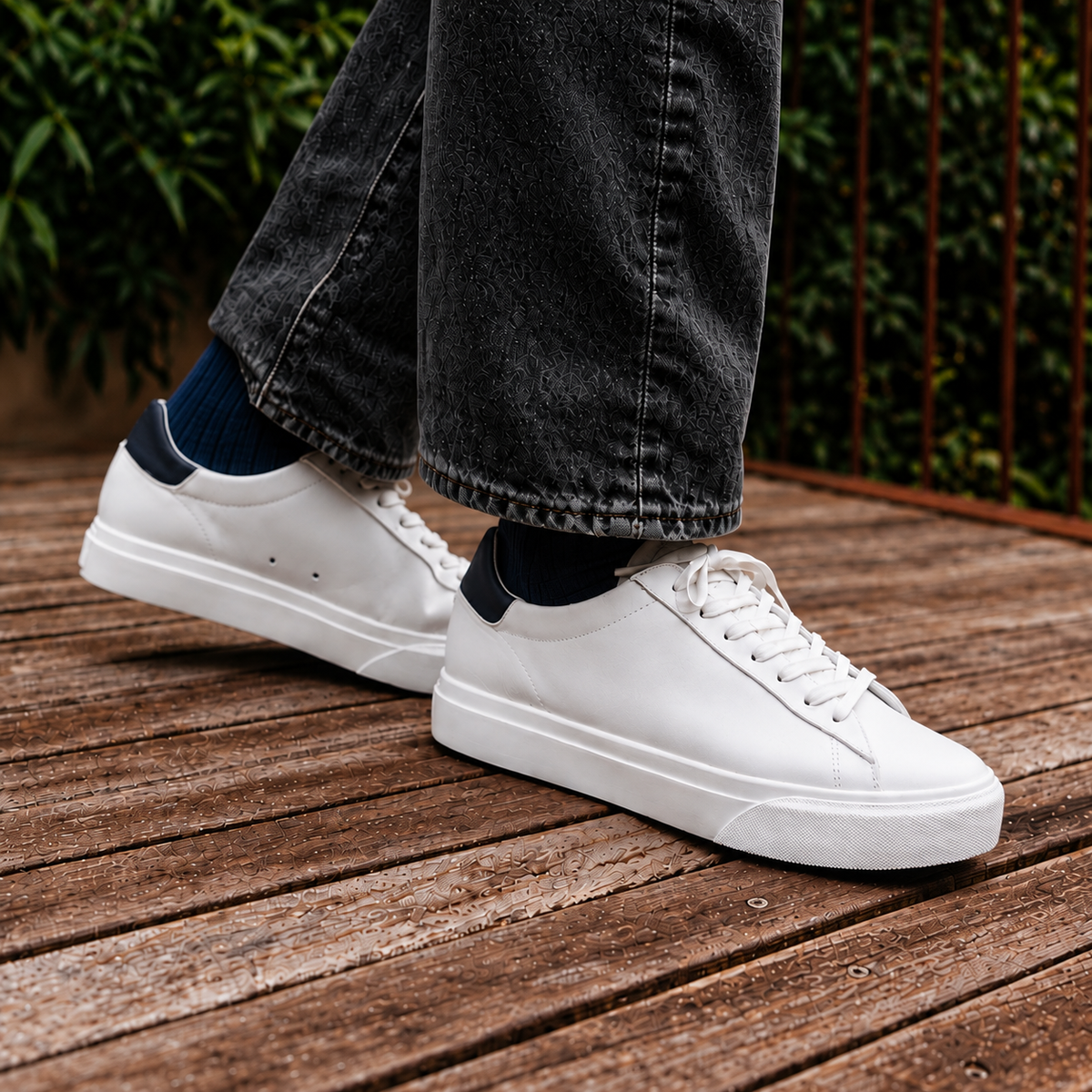 BRADLEY VENICE White Navy White worn with black jeans on a wooden terrace