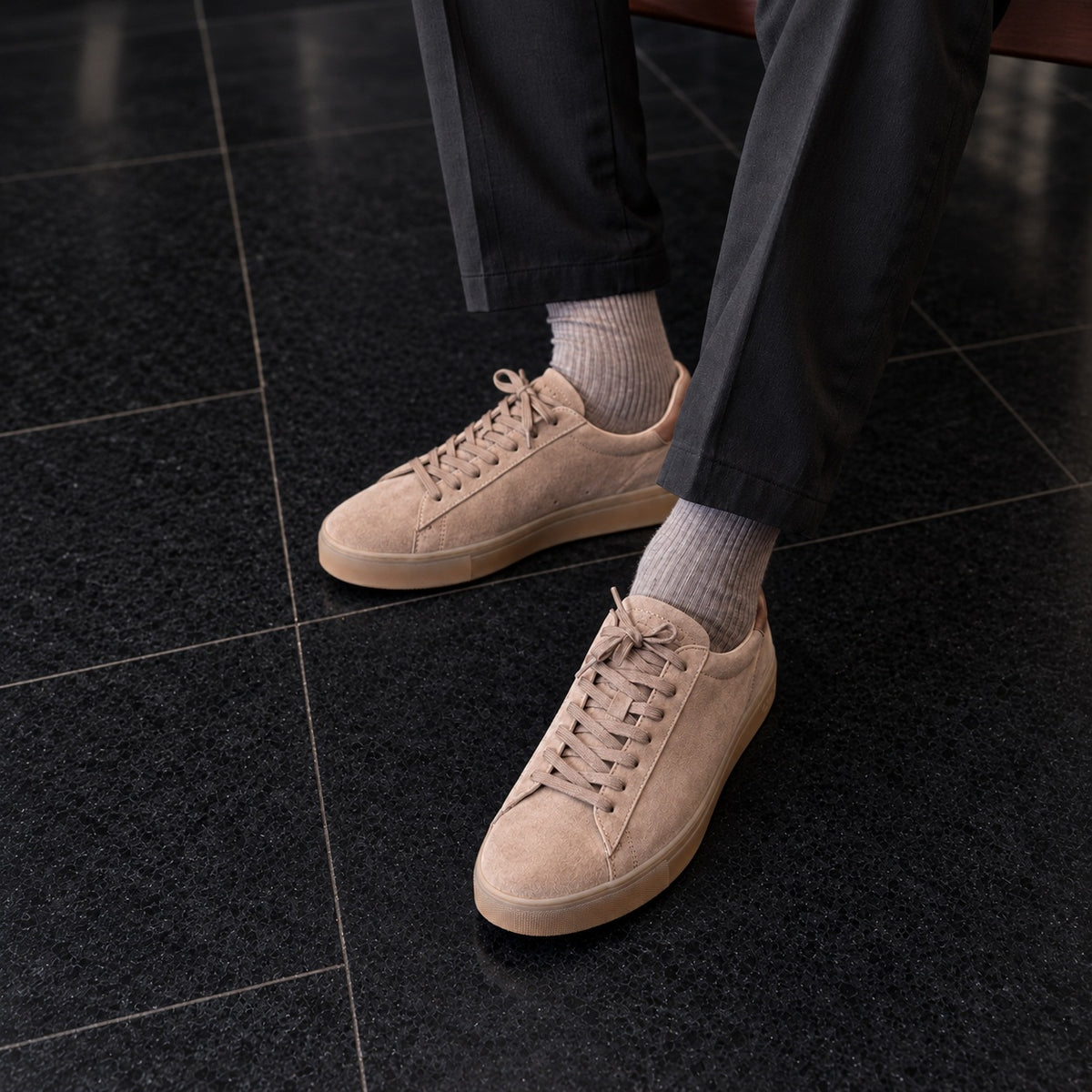 CLAE Bradley Portabella suede sneakers with gum soles worn with black trousers.